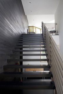 Chris stained all the interior wood black, including this wall by the entry stairs.