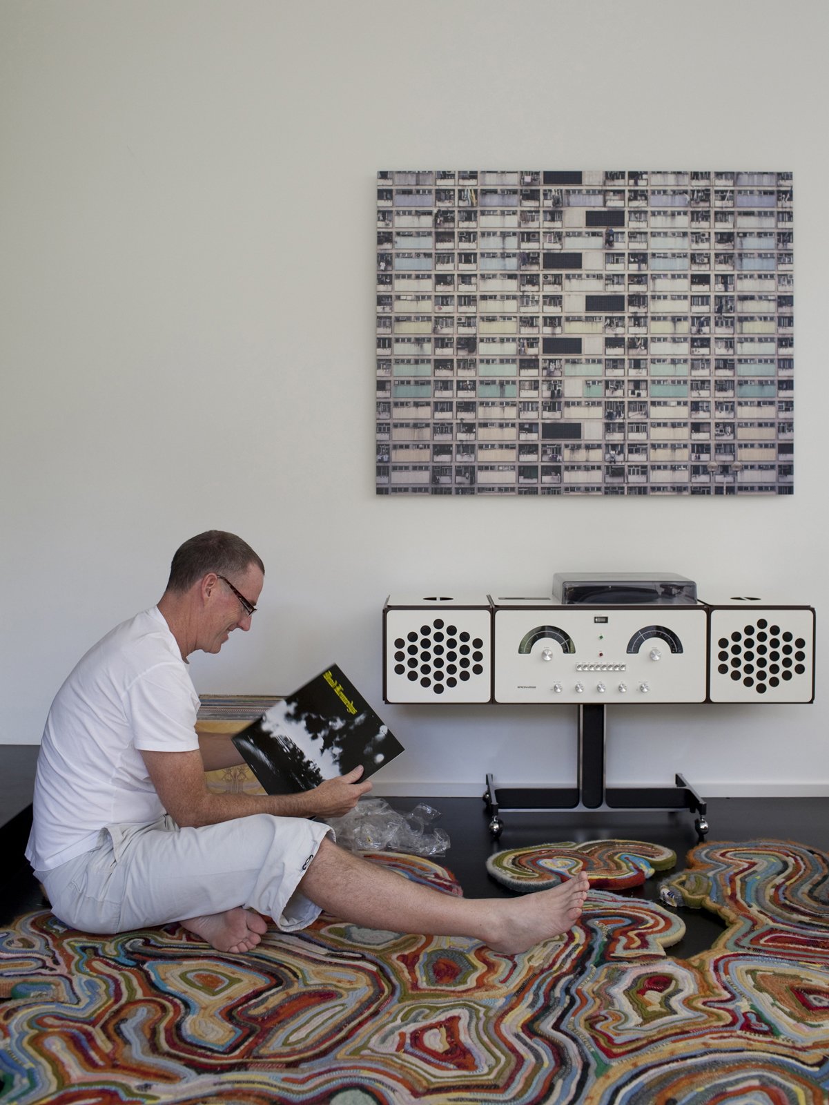 Sitting on the Recycled Blanket Rug by Tejo Remy and Rene VeenHuizen, Chris digs through his records looking for something to play on the new Brionvega RR226 by Achille Castiglioni.
