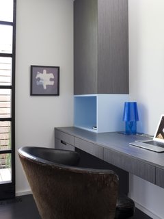 Lara's home office consists of a MacBook Air and Ferruccio Laviani Abat-Jour lamp for Kartell.