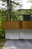 Modern home with Garage. “The first floor was about making something warm and woody that would blend into the natural environment,” architect Stephen Chung says of his Wayland, Massachusetts, home. “The second floor was a chance to experiment.” Photo of 16 Funky Facades