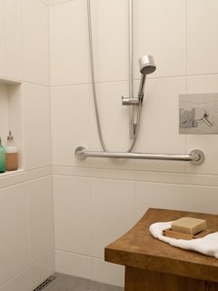 The shower can accommodate two, and has Hansgrohe heads of differing heights with separate controls from Cifial. The residents stayed away from a built-in bench and opted to switch out a variety of tables and benches as needed, to avoid dealing with the mold or water stains that quickly materialize in a built-in. Tile from Statements.