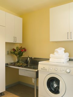 Near the front-loading machine in the laundry room is a utility sink Braitmayer found at a restaurant supply store; she had the legs cut to her height specifications. The cabinets are from IKEA. "Happy colors are really important in Seattle, because it’s often gray," says Sundstrom. "The buttery yellow is a good mood lifter."