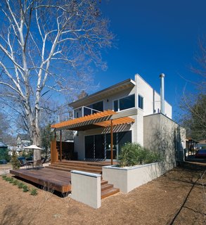 Triangle House Tours - Photo 2 of 30 - Instead of demolishing the existing house or adding a second story, the addition was added at the rear of the existing structure, separated by a new main entry courtyard. These new, public spaces take advantage of a connection to outdoor spaces at the rear of the lot.