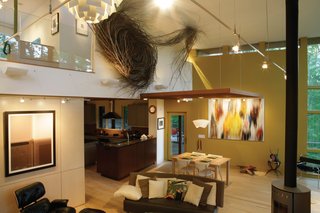 Triangle House Tours - Photo 6 of 30 - Inside the main volume, the master bedroom hovers over the living and dining area. Living areas maximize daylight with sleek, clerestory windows that give the illusion of a floating roof and yet protect sensitive artwork from direct sun.