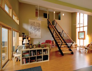 Triangle House Tours - Photo 11 of 30 - Three factory built modules were set apart so that the spanning site-constructed roof affords generous living space below. The family regularly gathers in this light-filled living area flanked by abundant north and south glazing.