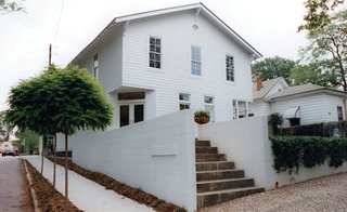 Triangle House Tours - Photo 14 of 30 - The building structure is a balloon-type frame supported by a central beam and columns. While the original look and proportions of the second floor elevations were maintained, the patch-worked walls below were redesigned to complement the upper story.