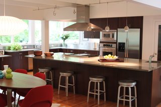 Triangle House Tours - Photo 18 of 30 - A screened porch and the kitchen were connected and are situated to enjoy southeast light and views of the site.