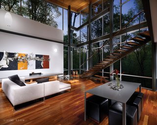 Triangle House Tours - Photo 24 of 30 - The entrance progresses from the top of the hill, across a bridge and into a balcony foyer. There the forest fills the interior through north-facing glass walls. A stair descends past the glass to the main living floor, which opens onto a partially secluded south-facing terrace below the bridge.
