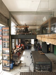 The first floor houses a machine shop--where prototypes for LED lighting and folding glass facades are fabricated for Larissa's architecture office, housed on the second floor along with Jeff's industrial design studio. The third story is the couple's and their seven-year-old daughter's living space, making for an ideal commute.