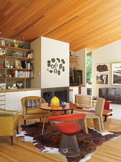 In the living room, local artwork and an elegant redwood ceiling watch over a side chair by Warren Platner for Knoll and an Easy Edges side chair by Frank Gehry for Vitra.