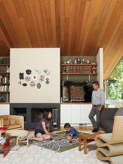As his parents look on, Apolo plans his commute under a fire-top piece by the artist Michael Ricardo Andreev and alongside a Wiggle chair by Frank Gehry.