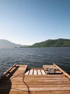 Down on the cedar dock, the view of nearby Bowen Island generates a dramatic foreground view, while the British Columbia mainland in the distance appears to be a world away.