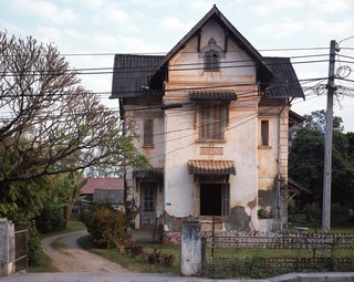 Living in Laos - Photo 10 of 14 - One of the things that struck me most when we first arrived in Vientiane was how so many of the old colonial houses were in such sad shape—it was like no one could care less. Slowly, I noticed that most were actually inhabited by families (Lao)—and often, more than one. Asking around, I learned that the predicament of these houses was very much in limbo; the government had taken possession of them in the years after the revolution (1975) as the owners began to flee. I was told if the former owners came back and showed proof of ownership there was a possibility of them getting their house back. I am sure few actually believe it. In the meantime, the tenants have no incentive to put their hard earned Kip (Lao currency) to fix something they don’t own and could be taken away from them at any time.