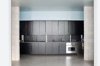"Neither of us were too keen on the idea of having handles on the closets or cabinets," says Atherton. So they cut narrow slots at the edge of the kitchen cabinet fronts to serve as hand pulls.