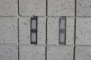 Seeking streamlined, unobtrusive switch plates, Atherton and Keener sent AutoCAD files of the four different styles they needed throughout the house to MarZee, a local water-jet cutting company, which cut 30 custom plates from one-eighth-inch aluminum for just $104—less than they would have cost off-the-shelf. The plates are inset and attached to the sandblasted masonry wall with Velcro.
