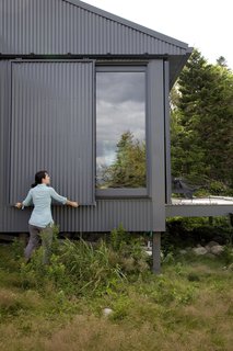 When Alex or Bruce leave the island, closing up shop is as simple as sliding panels of corrugated metal into place to protect the windows.