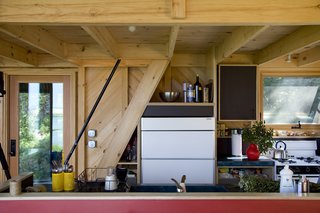 The Sunfrost refrigerator nearly disappears into the simple kitchen.