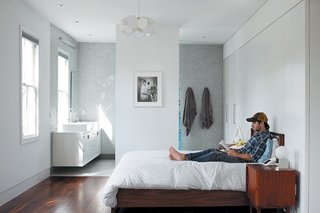 An 1850 schoolhouse in Milford, Pennsylvania - Photo 4 of 11 - The bedroom opens directly into the master bathroom to complete the open feel.