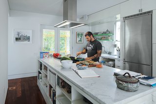 An 1850 schoolhouse in Milford, Pennsylvania - Photo 6 of 11 - To accommodate his passion for cooking, Renaldi insisted on the long Carrara marble countertop, a niche for cookware, and ultra-contemporary appliances.