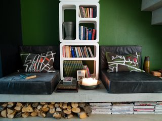 8 Ways to Organize Your Books with Storage Cubbies - Photo 1 of 8 - The reading corner can be turned into an extra bed. Schonning designed the leather poufs himself, and made the cushions from an Ikea carpet. Under the concrete slab there is room for wood, books and newspapers.