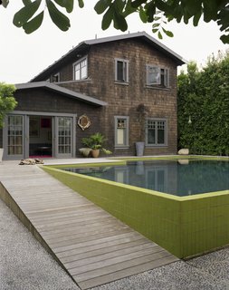 A seeded concrete walkway leads from the rear driveway—the entrance used most often—and into the yard. To create the look, each river rock was hand-placed in the wet concrete.