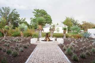 Hill worked with metal artist and designer George Sacaris to create a sculptural gas fire pit in her backyard. Using repurposed pipes uncovered during the renovation, Sacaris welded them together in a vertical formation. When the fire is flickering, it engulfs the sculpture and adds another note of drama to the outdoor area.
