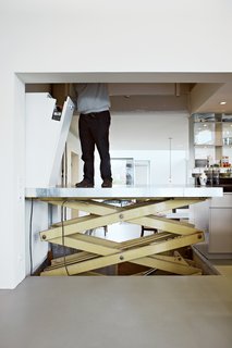 The recycled builder's elevator is a practical touch, and allows easy transportation of artwork and furniture between floors.