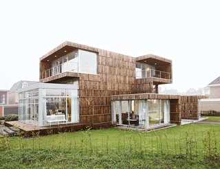 From the outside, the house appears as a composition of cubic volumes that barely hints at its reused nature. Expanses of glass, skylights, terraces, and balconies all strengthen the relationship between inside and outside and make the interior uniformly light.