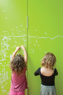 Just Redo It - Photo 5 of 9 - The couple initially painted partition walls between the children's room and their own with black metallic paint creating both a writing surface for the children and a magnetic bulletin board for notes. However, "the black looked too oppressive," Astrakhan says. So they applied several coats of lively lime green paint to brighten up that section of the house.