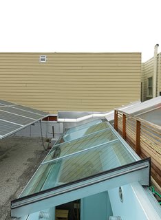 Just Redo It - Photo 9 of 9 - With just one side window, there was insufficient light and air in the center of the house. As a remedy the couple installed a custom Rollamatic retractable 24-by-7-foor skylight.
