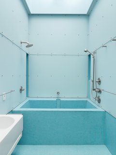 Just Redo It - Photo 6 of 9 - Dunbar describes the bathroom as an outside-in room because it has light, air, and sometimes, when it drizzles and the skylight left open, even rain. Designed for exactly these circumstances, a blue-glass mosaic tile floor is laid at an angle to drain with ease.