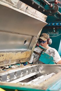 A worker operates the float-sink tank. Heavier, nonrecyclable materials sink to the bottom, leaving on the water's surface only rPET, which then becomes white rinse flake.