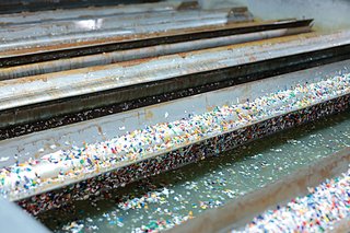 The rinse flake undergoes NURRC's patented UnPET process, in which the surface of the PET material is removed (depolymerized) and the remaining compound is roasted to remove any volatile organic content.