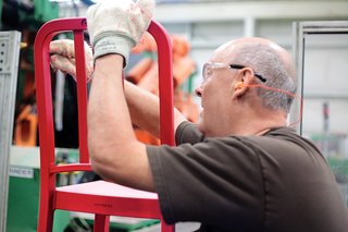 A worker smoothes any imperfections before manually installing the H-brace.