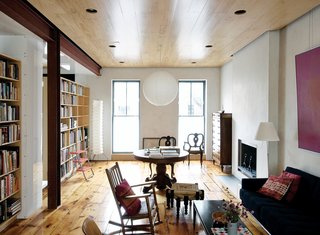 Family Home Renovation in Brooklyn - Photo 4 of 28 - On the parlor level, the pigmented plaster walls eschew the finish of paint. A modest reveal between the ceiling plane and the walls ingeniously accommodates a concealed picture rail that runs the perimeter of the room. The 1968 painting above the sofa is by op-artist Julian Stanczak.