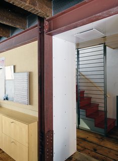 Family Home Renovation in Brooklyn - Photo 9 of 28 - The exposed steel beams delineate access areas from the rooms. The staircase system and fireplaces were fabricated by Wesley Martel.