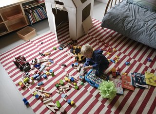 Family Home Renovation in Brooklyn - Photo 23 of 28 - Paul spreads out his toys on a rug from Pottery Barn.