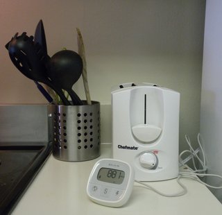 Finding My Latent Energy Use - Photo 1 of 4 - The Belkin Conserve Insight taking a reading of our refrigerator. The number jumped up and down depending on how hard it was working to maintain the internal temperature—ranging from 900-plus watts after we'd had the door open for a minute to 0 watts after it reached its set temperature.