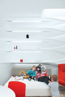 The bed, usually scattered with Legos and toy cars, "is a big playground for the kids," says Krastev.