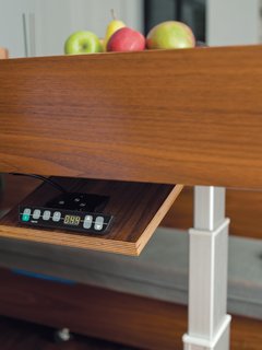 The table's hydraulic controls and hidden drawers.