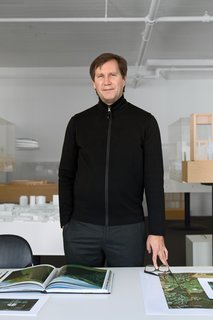 Thomas Phifer stands in his west SoHo office and studio, with the firm’s exquisitely crafted architectural models behind him. The room’s all-white walls and ceiling are receptive to shadow and sunlight: "I love turning out the lights here; you see the color of the walls changing all day long," says Phifer.