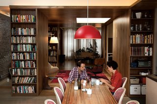 Adrian Jones and Allison Silverman sit at their reclaimed wood dining table. Eco-mindedness is a matter-of-fact part of everyday life for the couple and the designer, Garrick Jones. "Sustainability comes from flexibility and planning for the long term," Garrick says. "This is not a glammed-up loft."