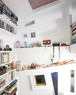 Communal Living on a Budget in Brooklyn - Photo 9 of 13 - Ionescu’s room has built in shelving for his eclectic collections. "We embrace everything—new, old, anything that embraces the truth in architecture," says Ionescu. "We’ve been compared to the Deconstructivists, but we like things that are decorative or made by hand—16th century objects, Art Nouveau, anything that has an aesthetic truth to it."
