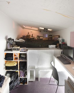 Communal Living on a Budget in Brooklyn - Photo 12 of 13 - Located at the rear corner of the installation, down a progressively narrowing hallway, and reached by a steep staircase, Eric Juron’s attic-like space is the most remote of the bedrooms. A window over his desk looks down through the gap between the Major and the Minor.