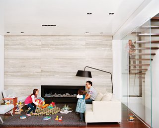 Five Boroughs in 48 Hours - Photo 17 of 32 - When the Hsus found themselves expecting a third child, they engaged Lang to enclose the upper part of their double-height living room to create a fourth bedroom and playroom-study upstairs. Additionally, Lang resurfaced the fireplace wall with massive slabs of filled silver travertine marble. The slabs were so large that one of them broke an adjoining floor-to-ceiling glass pane during installation.
