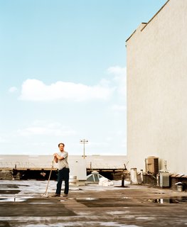 Five Boroughs in 48 Hours - Photo 18 of 32 - Cinematographer Wilmot Kidd sweeps the roof of the Red Hook industrial building that contains his home.