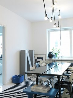 The apartment has no couch; "We simply don’t need one—plus it would take up a lot of space," says Susanna. A string of outdoor lights fosters a cozy atmosphere. "I tried them out once for a party and they looked so nice that I decided to keep them. The light is warm and inviting."