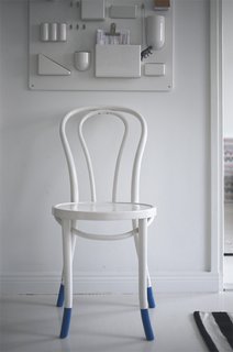 In the entryway, a plastic Uten.Silo organizer by Vitra shelters keys and other bits of potential clutter. A white-painted cafe chair suits the minimalist color scheme.