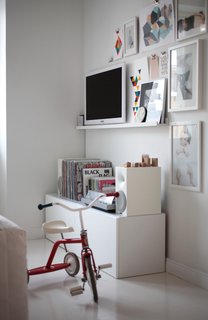 The master bedroom is a real continuation of the main living space; Varpu rides her tricycle through, and the whole family gathers on the bed to watch movies and cartoons on the television across the room.