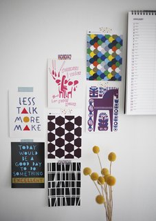 Instead of splurging on expensive framed art, Susanna tapes postcards and images cut from magazines to the wall. They're bright, colorful, and easy to swap out as she likes.